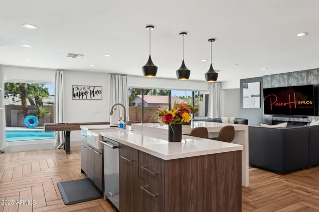 a bedroom with a large bed and a chandelier