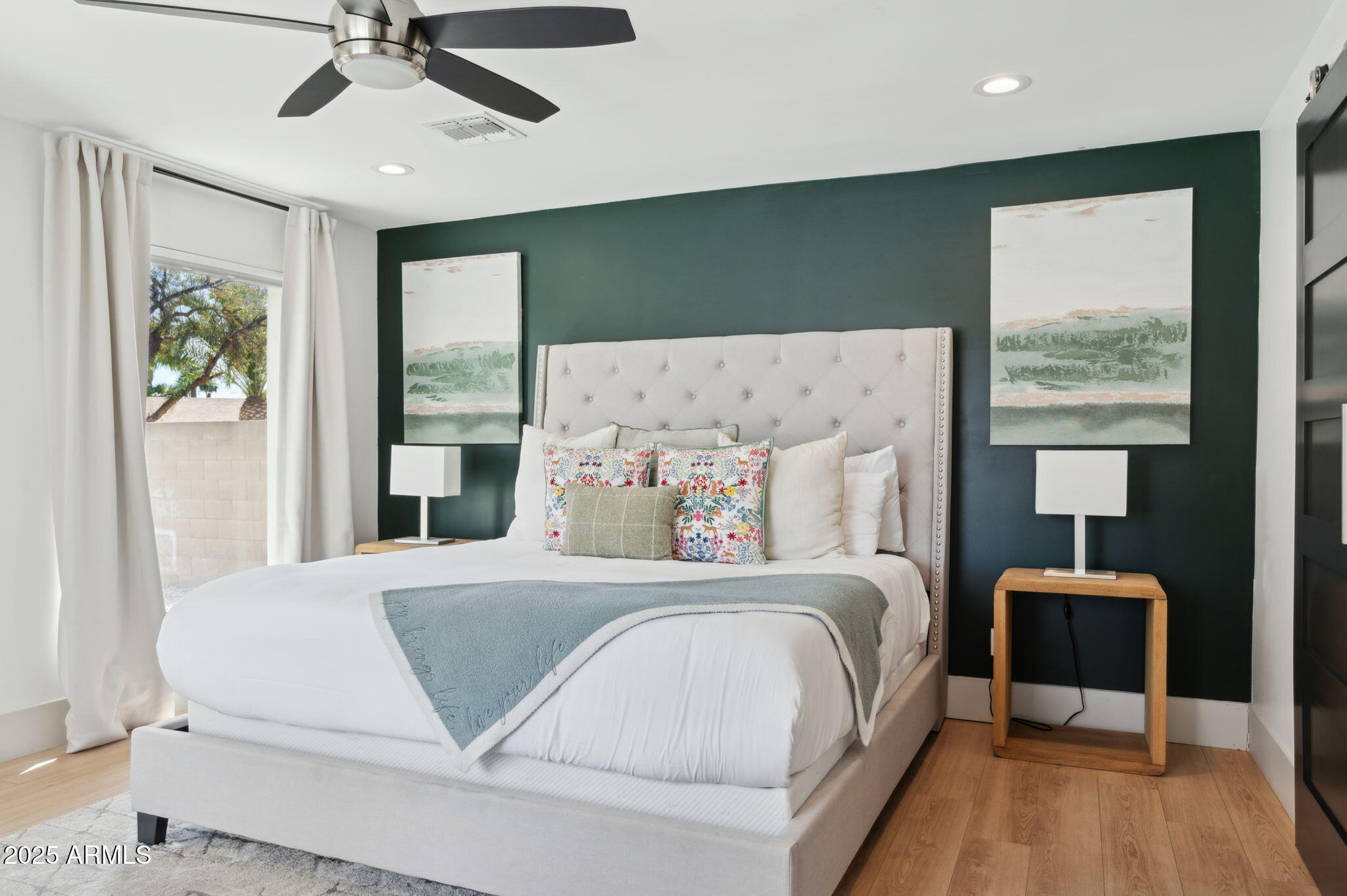 5301 East Tierra Buena Lane Scottsdale, AZ 85254 - Photo 17 of 61 a bedroom with a large bed and a chandelier