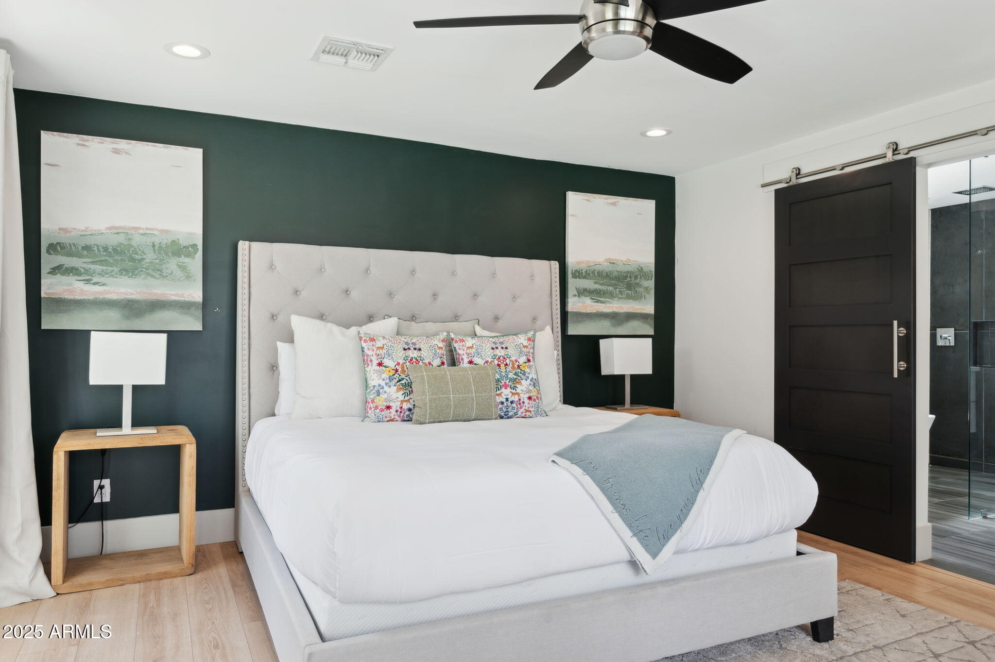 5301 East Tierra Buena Lane Scottsdale, AZ 85254 - Photo 18 of 61 a bedroom with a large bed and a chandelier