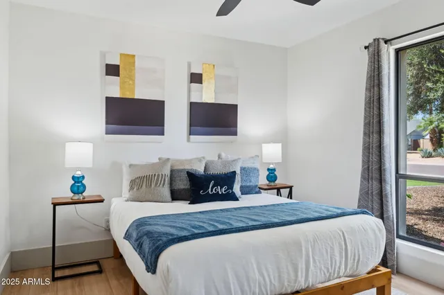 a bedroom with a bed and wall painting