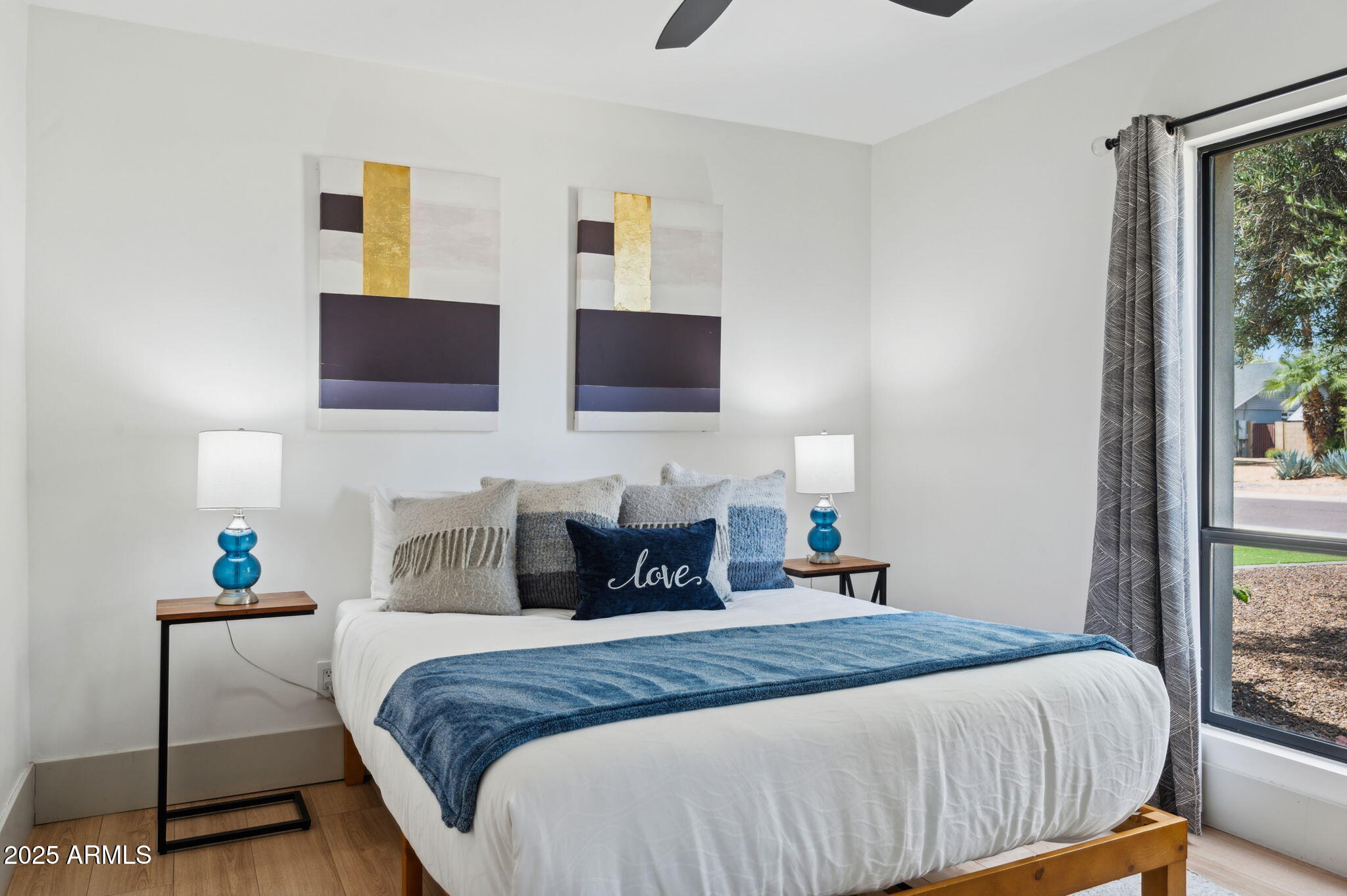 5301 East Tierra Buena Lane Scottsdale, AZ 85254 - Photo 25 of 61 a bedroom with a bed a flat screen tv and painting on the wall