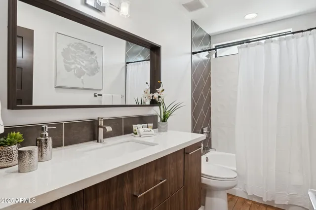 a large bed sitting in a bedroom next to a window