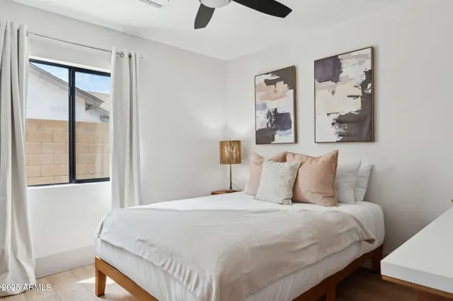 a large bed sitting in a bedroom next to a lamp