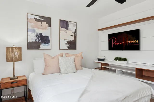 a bedroom with a bed and a flat tv screen