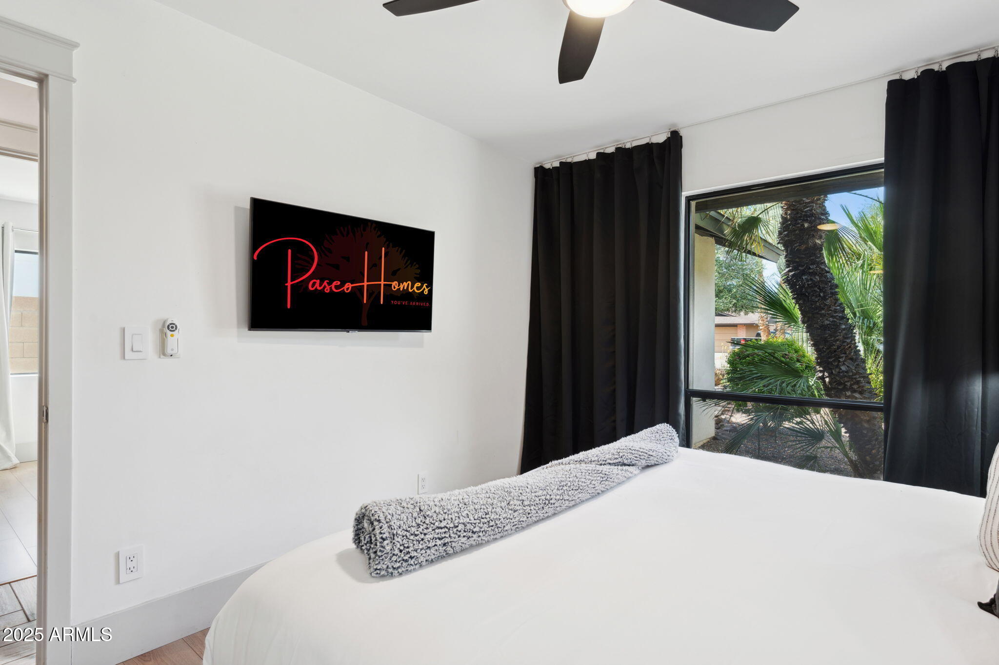 5301 East Tierra Buena Lane Scottsdale, AZ 85254 - Photo 35 of 61 a bedroom with a bed and a flat tv screen