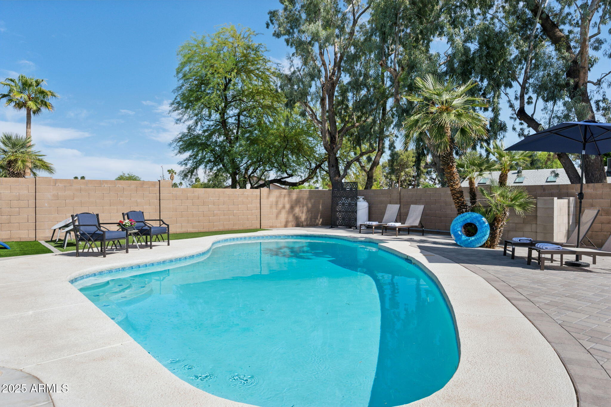5301 East Tierra Buena Lane Scottsdale, AZ 85254 - Photo 37 of 61 a swimming pool with outdoor seating and yard