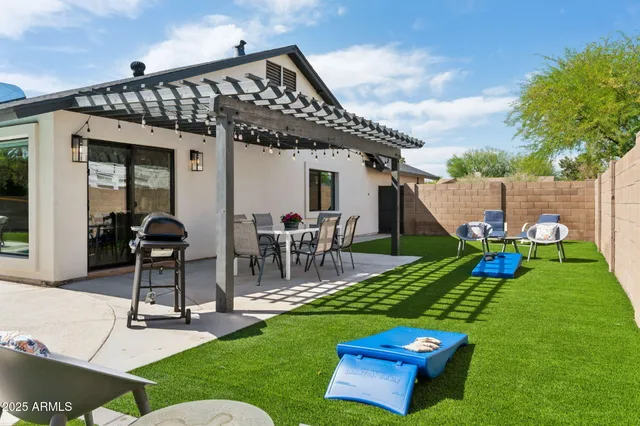 a view of a patio with table and chairs under an umbrella