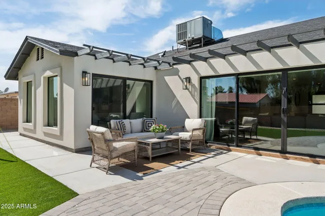 a living room with fireplace furniture and a potted plant