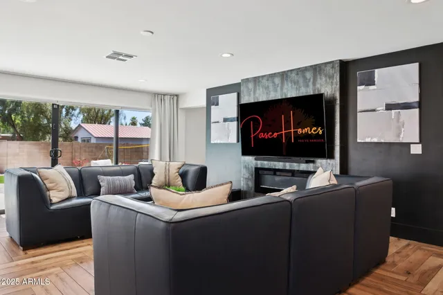 a living room with furniture and a fireplace