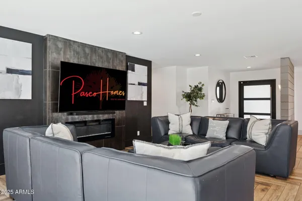 a living room with furniture and kitchen view