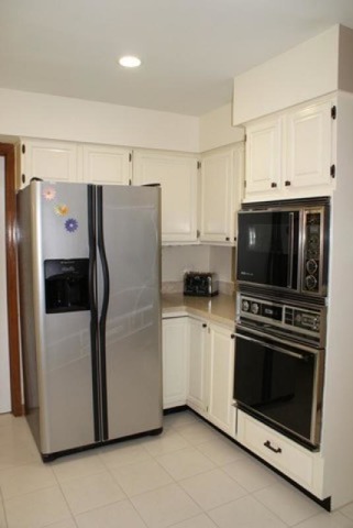4259 Keim Road Lisle, IL 60532 - Photo 9 of 25 a white refrigerator freezer and a stove sitting inside of a kitchen