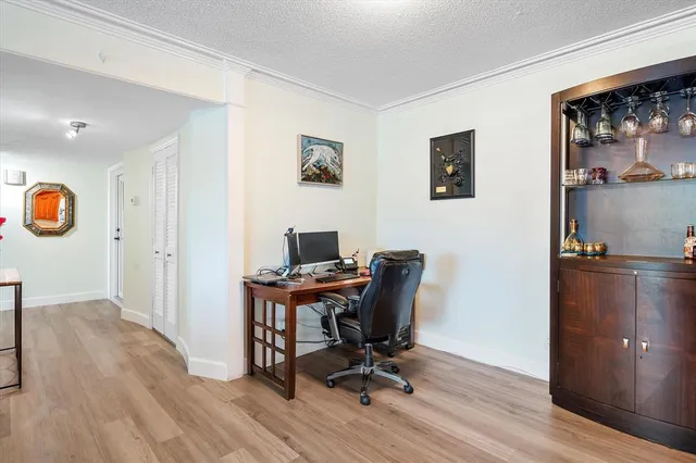 a view of a workspace with furniture and a window