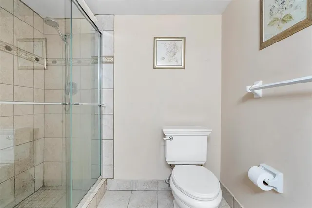 a white toilet sitting next to a bathroom sink