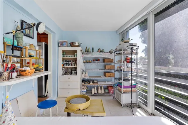 a living room with furniture and book shelf