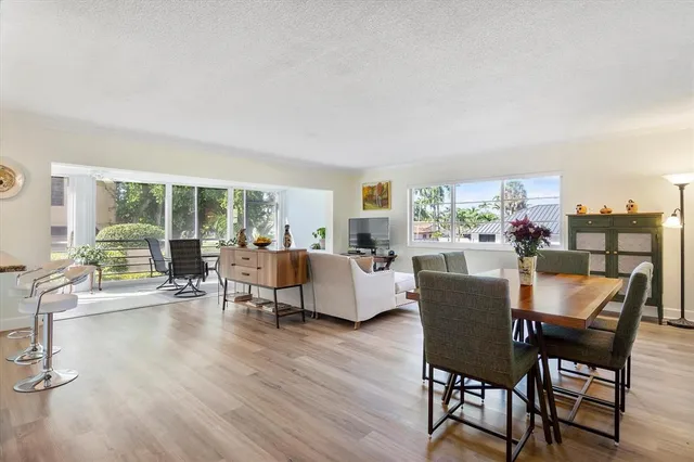 a dining room with furniture and wooden floor
