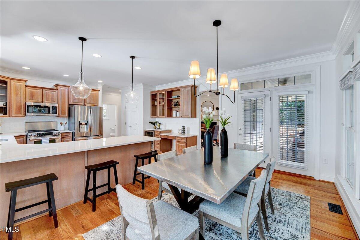 201 Brooks Avenue Raleigh, NC 27607 - Photo 11 of 44 a dining room filled with furniture and wooden floor