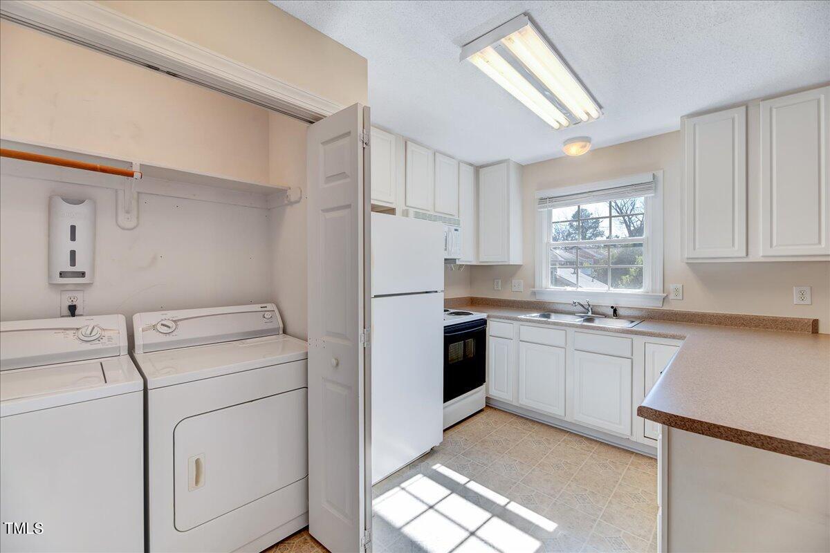 201 Brooks Avenue Raleigh, NC 27607 - Photo 27 of 44 a kitchen with a stove a sink and a refrigerator