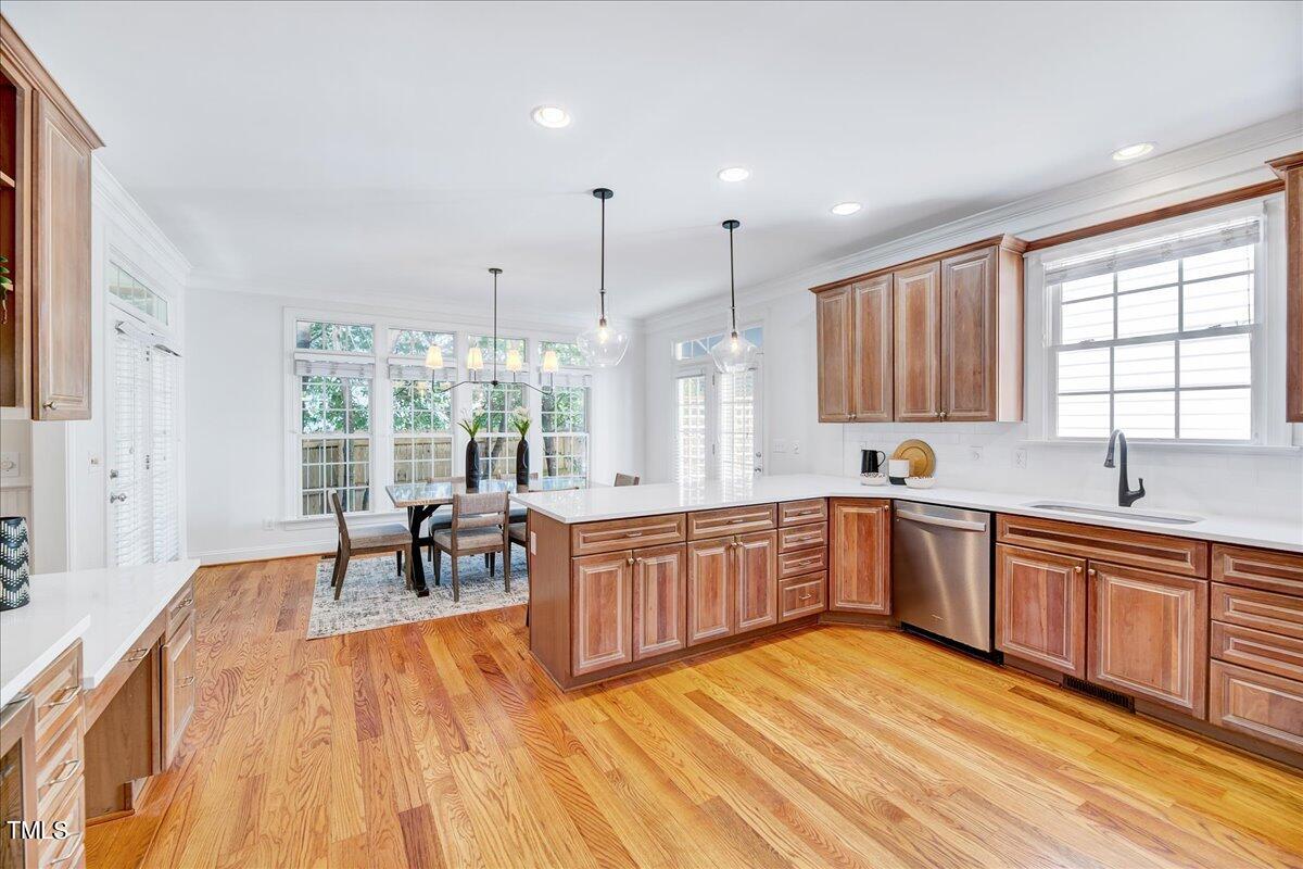 201 Brooks Avenue Raleigh, NC 27607 - Photo 7 of 44 a large kitchen with kitchen island a large window a sink and stainless steel appliances