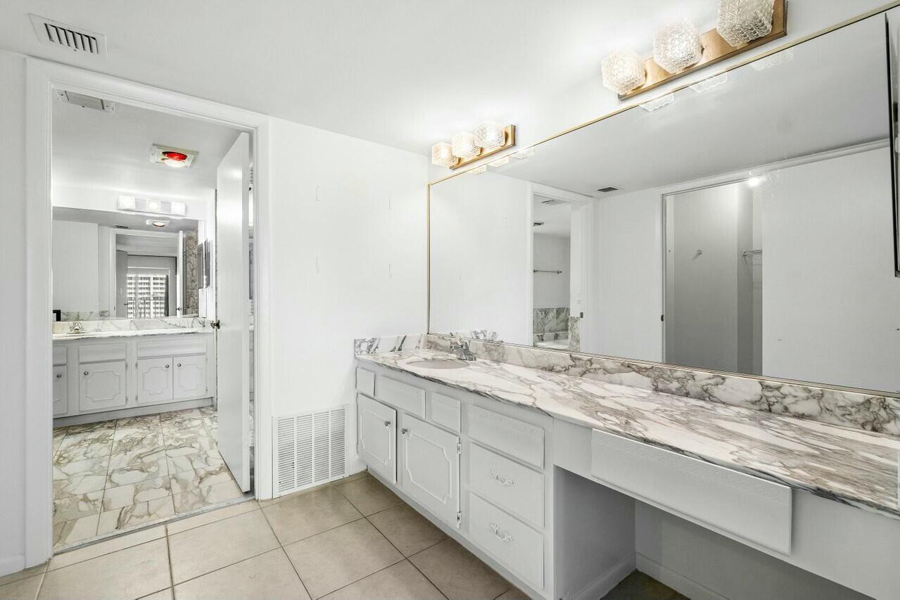 4001 North Ocean Boulevard, Unit 1503 Boca Raton, FL 33431 - Photo 25 of 46 a bathroom with a granite countertop sink mirror and double