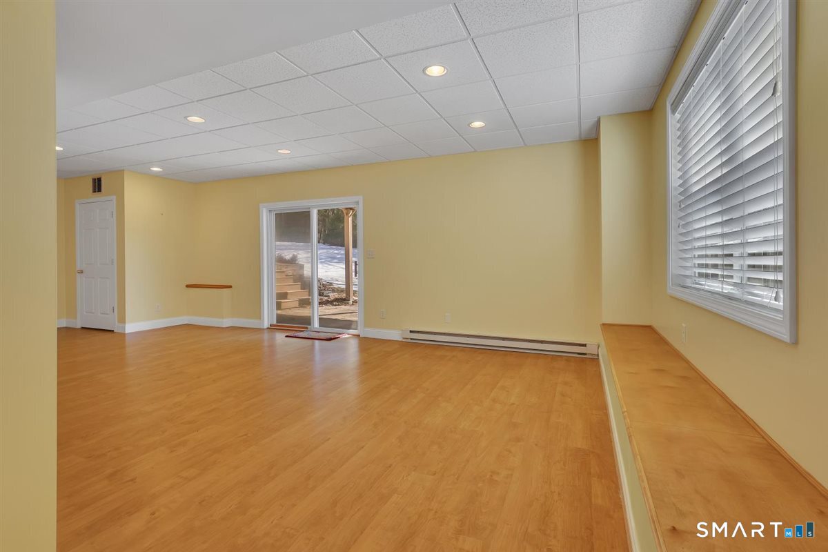 25 Fenwick Drive Avon, CT 06001 - Photo 36 of 40 a view of an empty room with wooden floor and a window