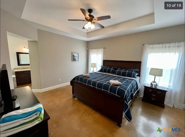 a bedroom with a bed window and a couch