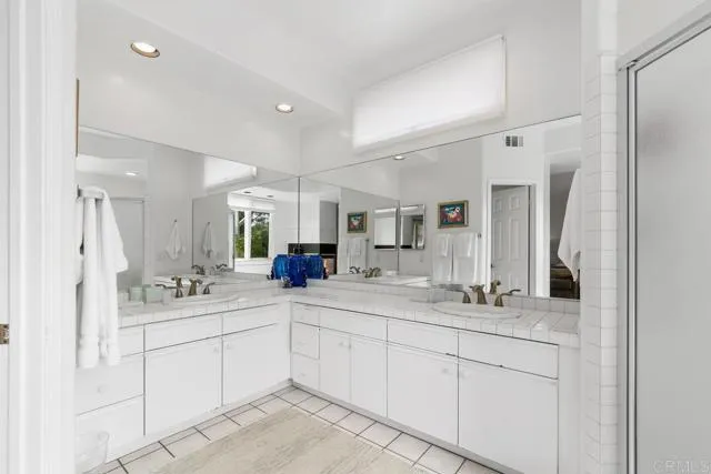 892 Del Mar Downs Road Solana Beach, CA 92075 - Photo 18 of 19 a bathroom with double sink and a mirror