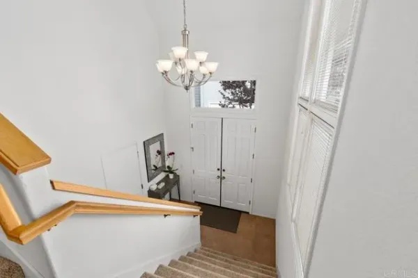a living room with furniture a flat screen tv and a window