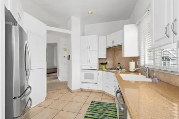 a kitchen with stainless steel appliances a refrigerator sink and cabinets