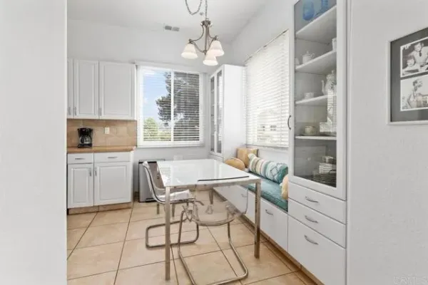 a view of a roof deck with table and chairs and wooden floor