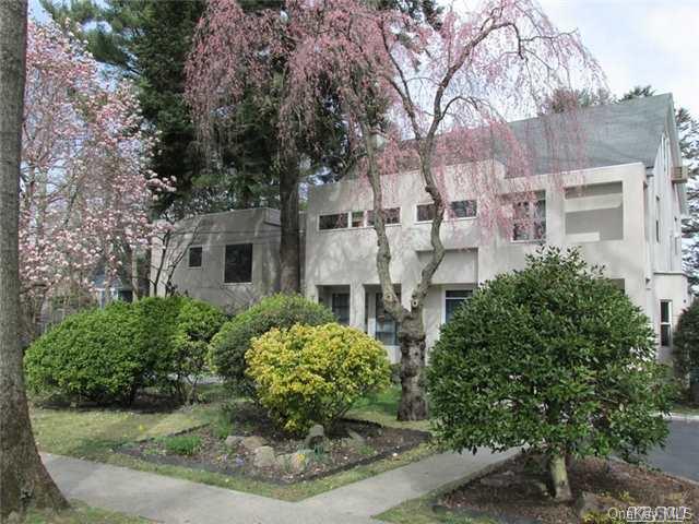 112 Huntington Road Port Washington, NY 11050 - Photo 1 of 1 a view of a white house next to a yard