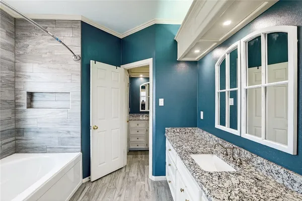 a bathroom with a tub and shower