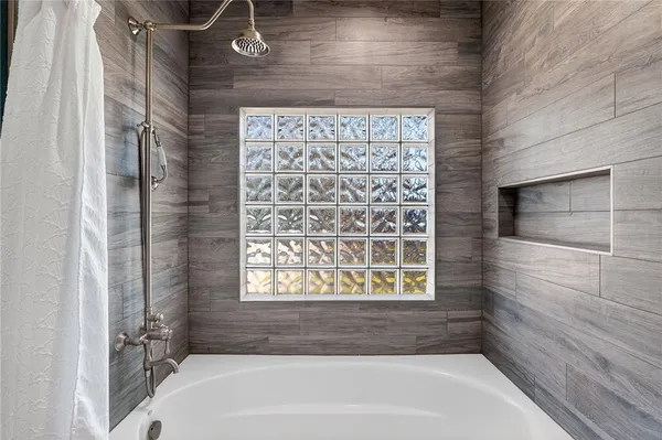 a bathroom with a bathtub and shower