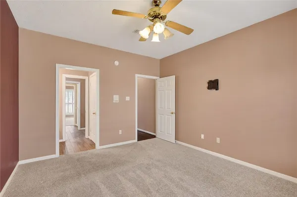 a view of a livingroom with a chandelier fan