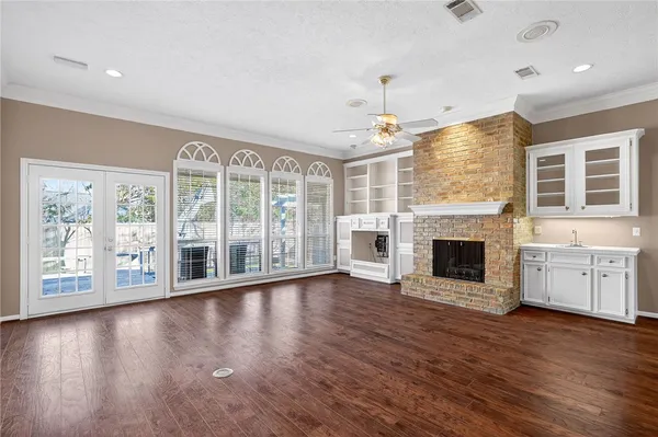an empty room with wooden floor and fireplace