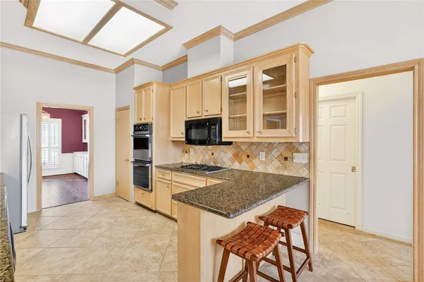 a kitchen with a stove a sink and a refrigerator
