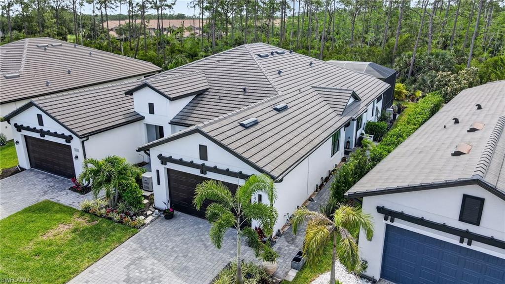 a aerial view of a house with a yard and potted plants