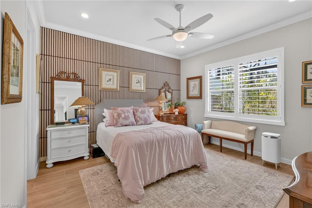 14628 Kingfisher Loop Naples, FL 34120 - Photo 13 of 39 a bedroom with a large bed and a chandelier