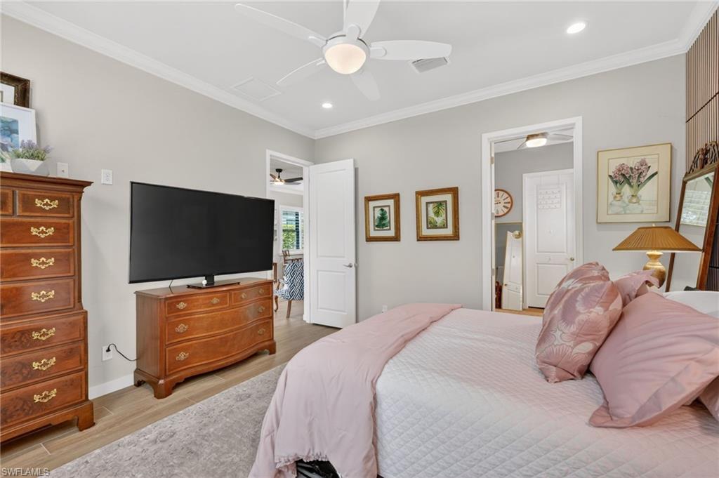 14628 Kingfisher Loop Naples, FL 34120 - Photo 14 of 39 a bedroom with a bed and a flat screen tv