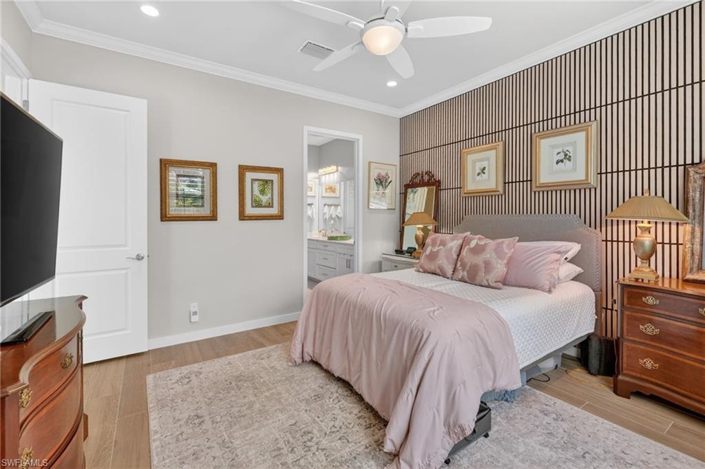 14628 Kingfisher Loop Naples, FL 34120 - Photo 17 of 39 a bedroom with a bed and a flat screen tv