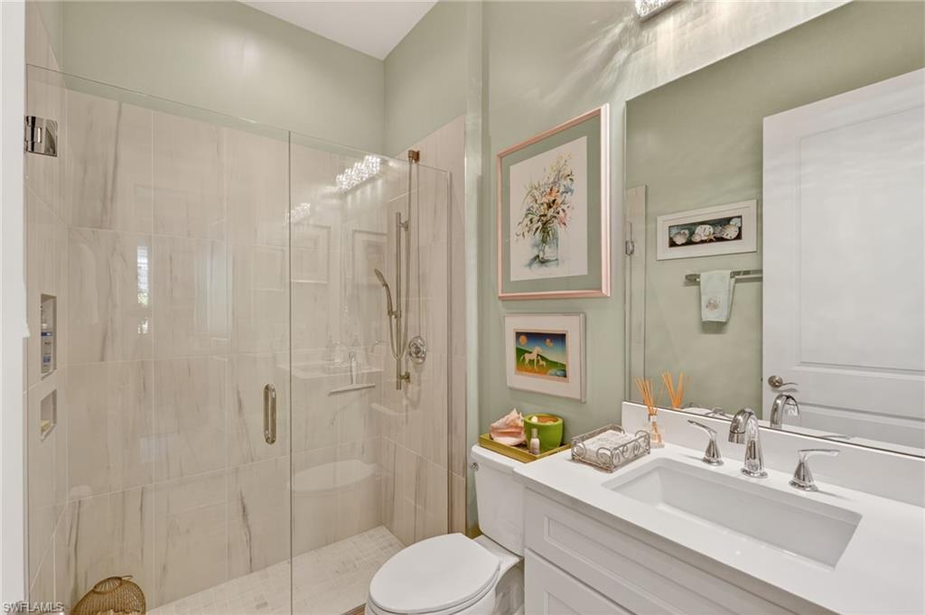 14628 Kingfisher Loop Naples, FL 34120 - Photo 20 of 39 a bathroom with a sink toilet and shower