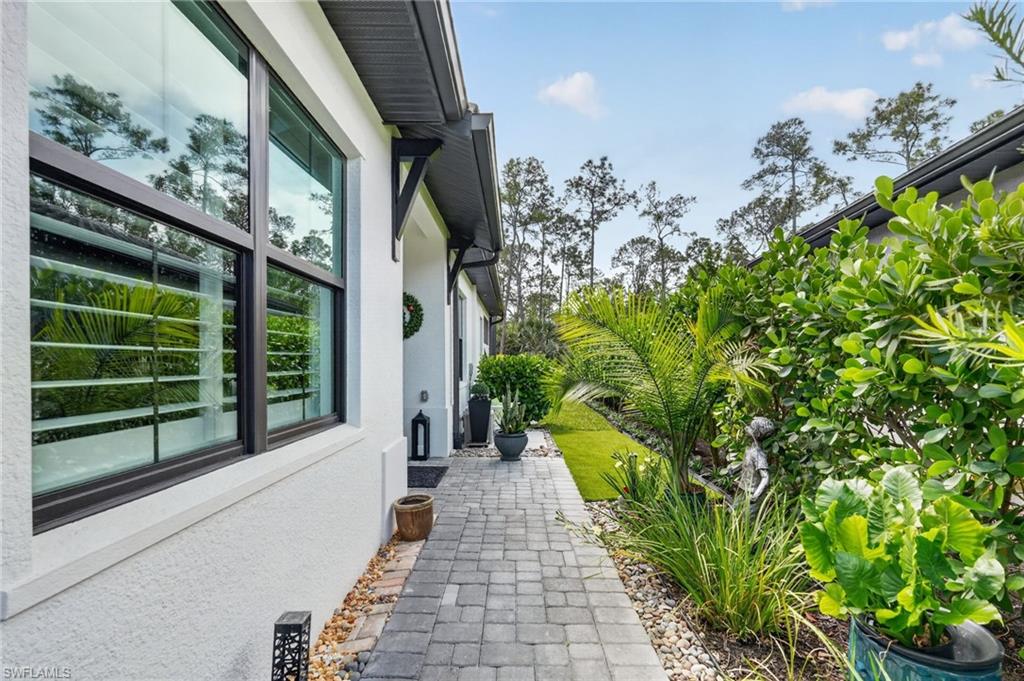 14628 Kingfisher Loop Naples, FL 34120 - Photo 2 of 39 a view of a pathway of a house with a fountain