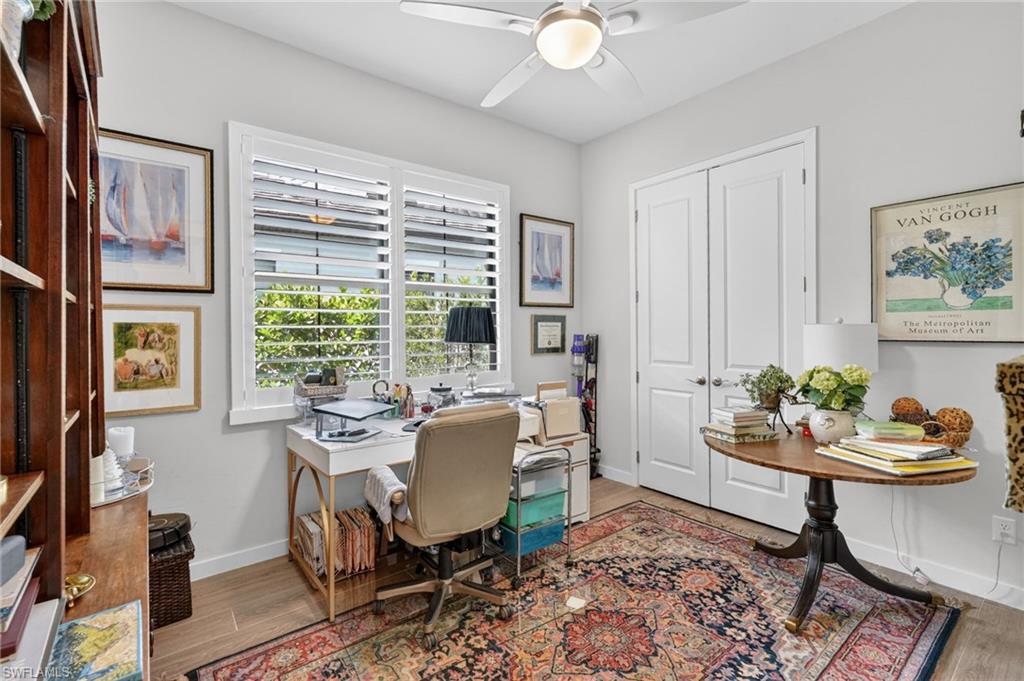14628 Kingfisher Loop Naples, FL 34120 - Photo 22 of 39 a view of a dining room with furniture a rug and wooden floor