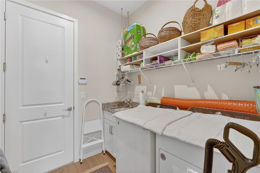 14628 Kingfisher Loop Naples, FL 34120 - Photo 23 of 39 a utility room with dryer and washer