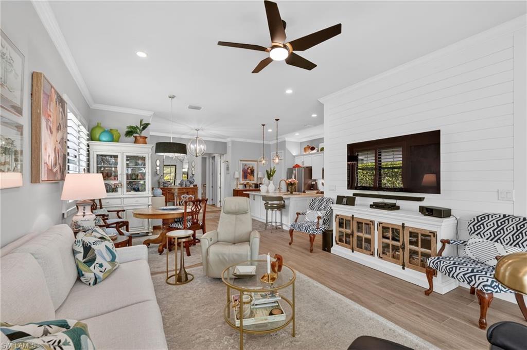 14628 Kingfisher Loop Naples, FL 34120 - Photo 6 of 39 a living room with furniture and a flat screen tv