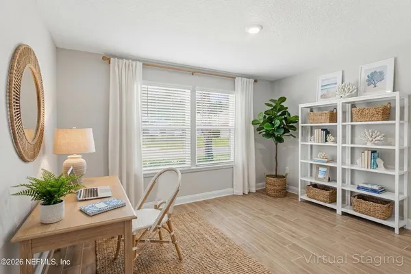 a kitchen with a sink a stove a refrigerator and white cabinets with wooden floor