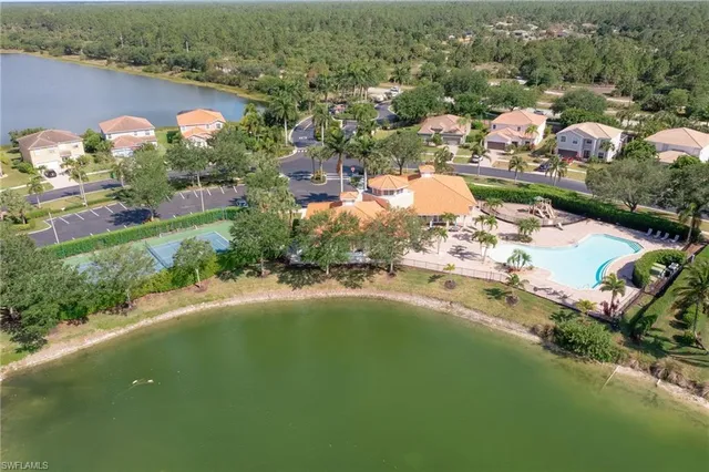 an aerial view of residential houses with outdoor space and river