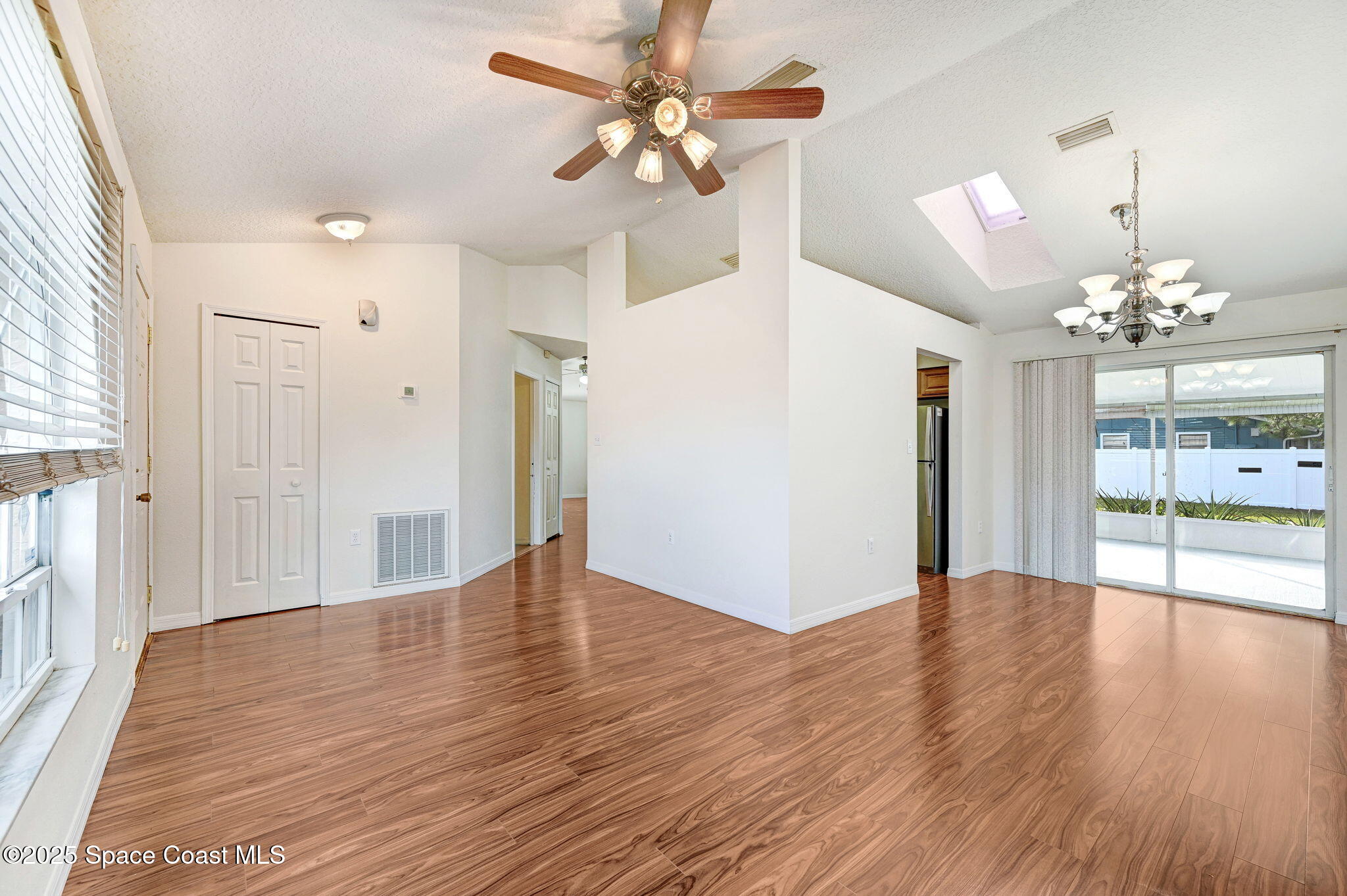 6094 Cardiff Avenue Cocoa, FL 32927 - Photo 12 of 48 a view of an empty room with window and wooden floor