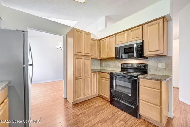 a kitchen with stainless steel appliances a stove microwave and a refrigerator