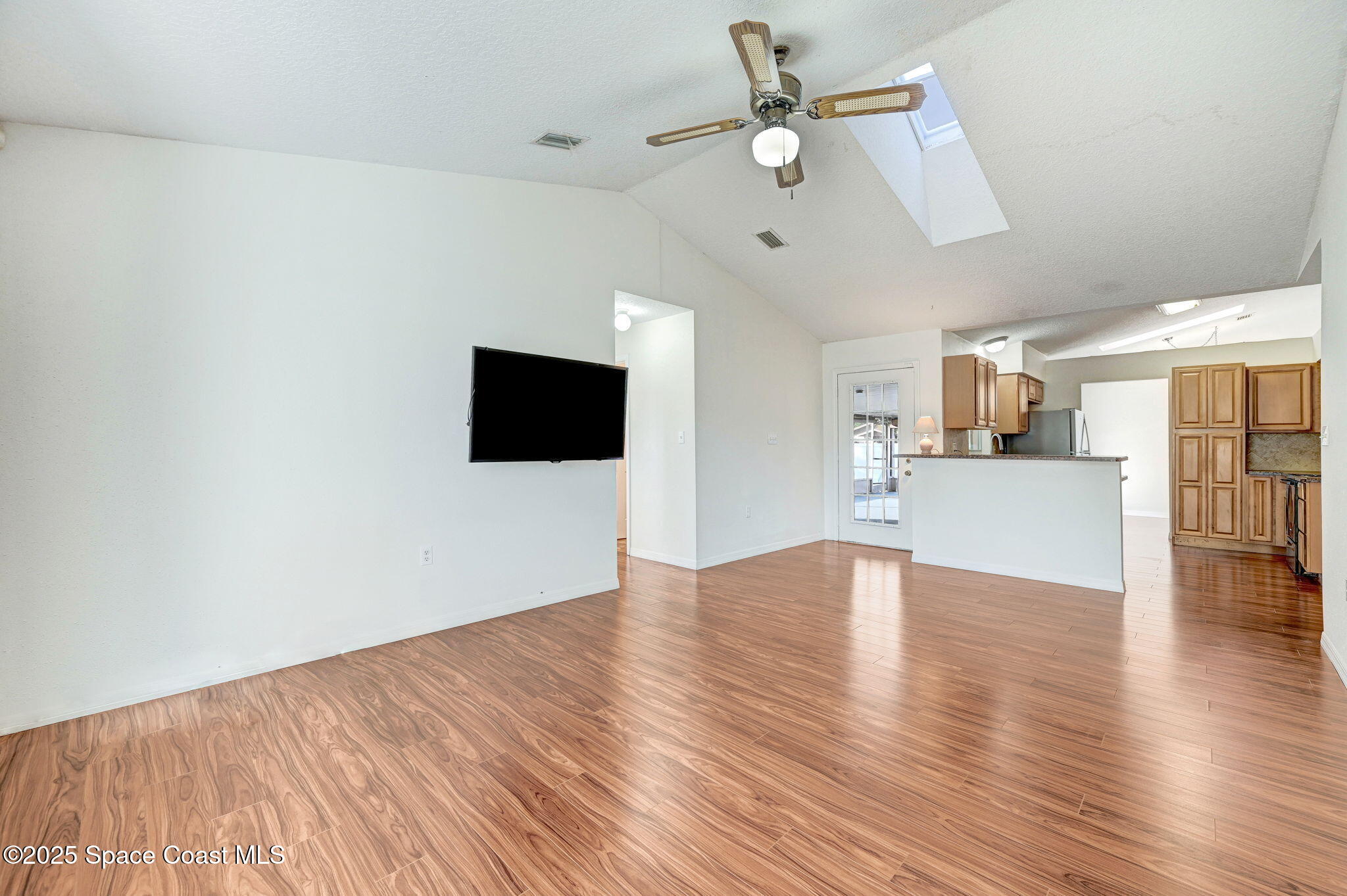 6094 Cardiff Avenue Cocoa, FL 32927 - Photo 20 of 48 a view of a livingroom with wooden floor and a ceiling fan