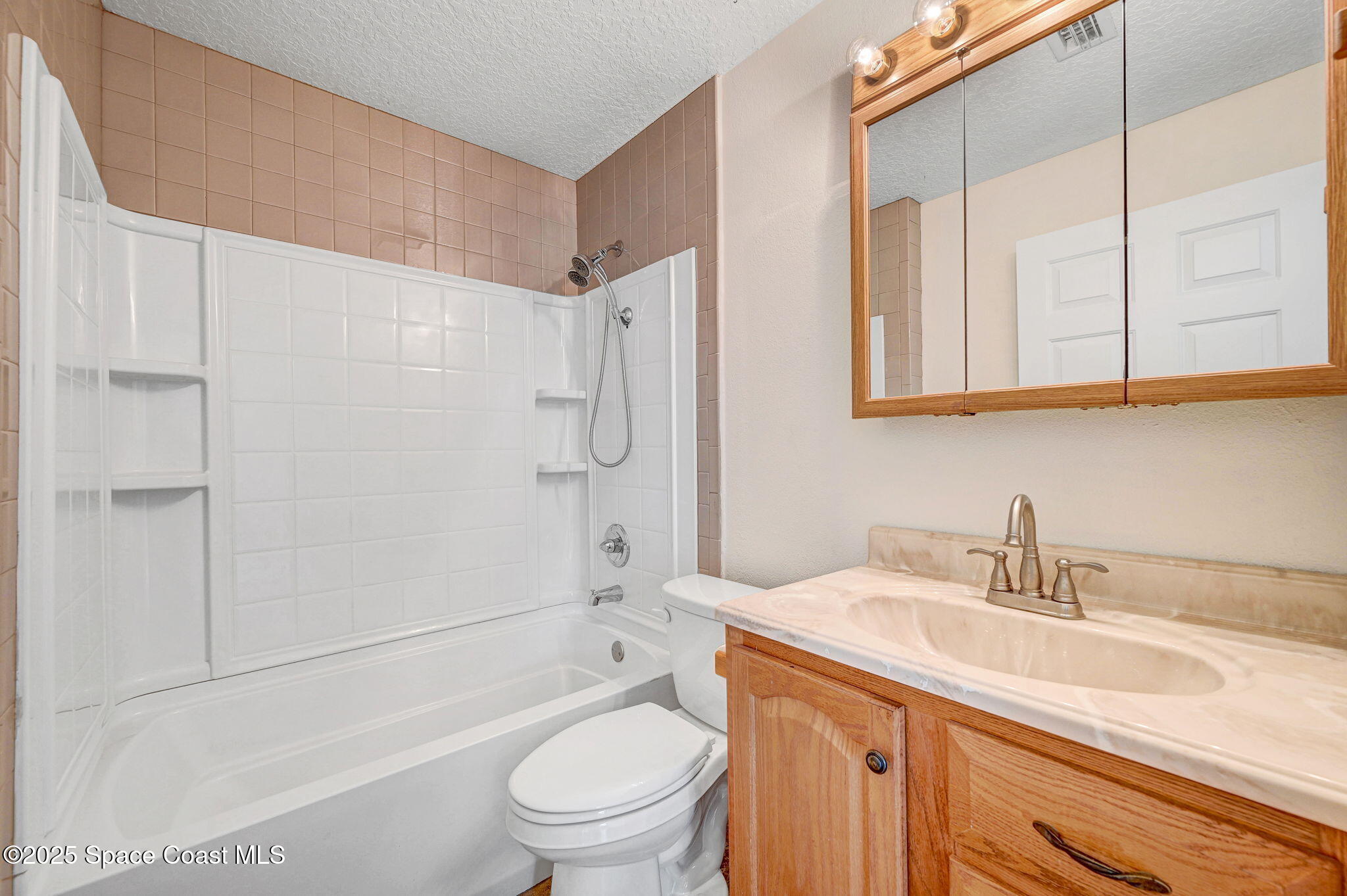 6094 Cardiff Avenue Cocoa, FL 32927 - Photo 31 of 48 a bathroom with a sink a toilet and shower